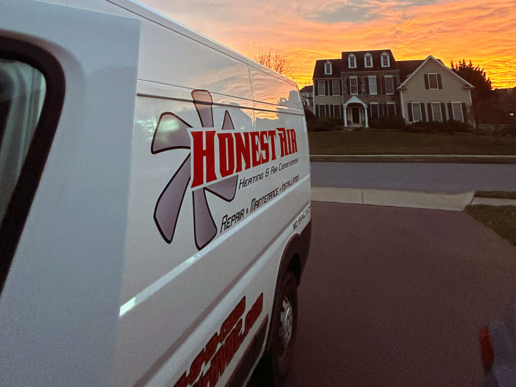 Honest Air Van sitting in front of a home during a beautiful sunset